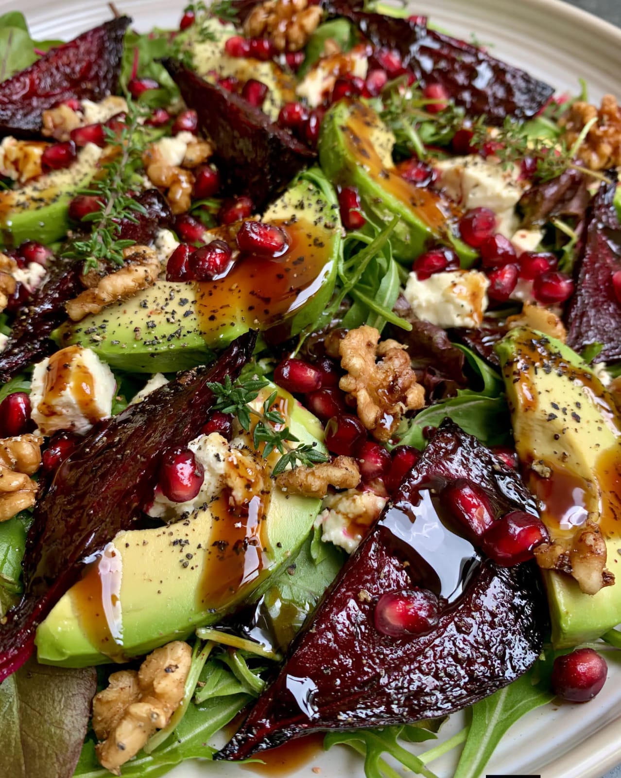 Beetroot Feta Avocado Salad with roasted beetroot, creamy feta, ripe avocado, mixed greens, toasted nuts, and honey balsamic drizzle