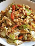 Chicken Cabbage Stir Fry with tender chicken strips, shredded cabbage, carrots, bell peppers, and savory garlic ginger sauce