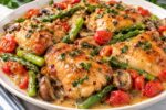 Spring Blossom Chicken with tender chicken, baby potatoes, carrots, peas, asparagus, lemon, fresh herbs, and creamy garlic sauce